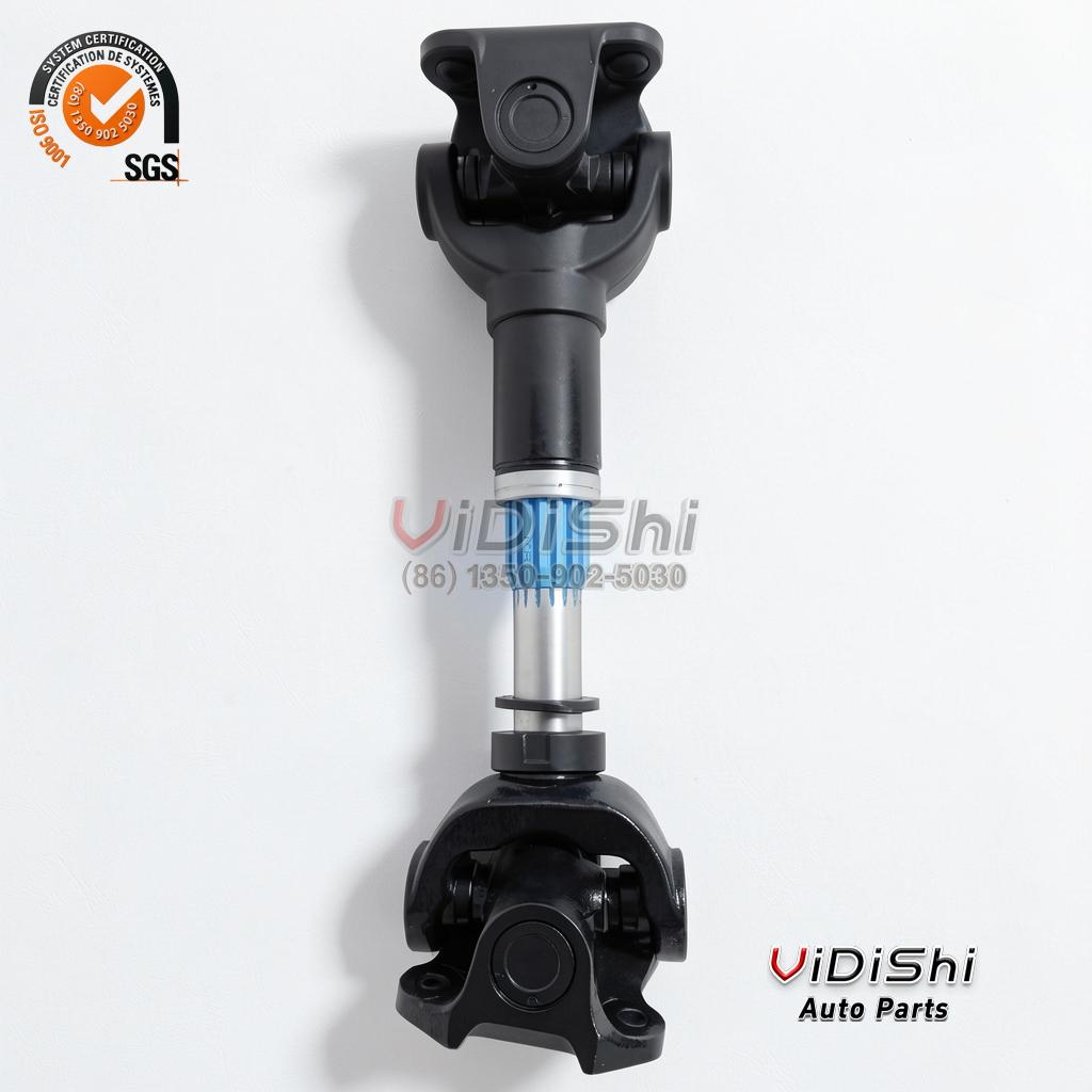 Cardan shaft standing upright with black flange yokes and an exposed splined slip section