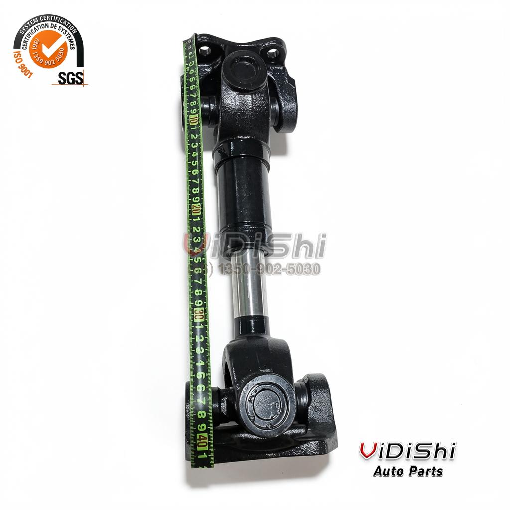 919473-1 Cardan Shaft with 5-155X U Joint for Trucks 3 Cardan shaft standing upright with a green tape measure laid along the shaft body