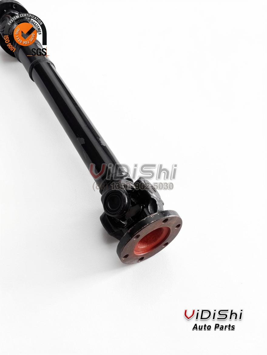 Drive shaft stood vertically with black tube, slip spline section and round flanges at both ends