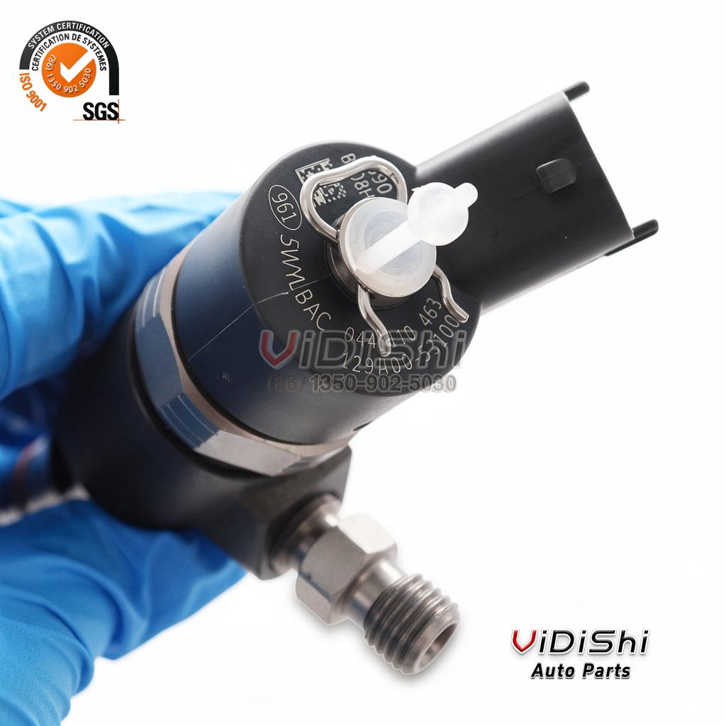 All Products 7 A 0445110464 injector held in a gloved hand with the solenoid head, connector and inlet union in view