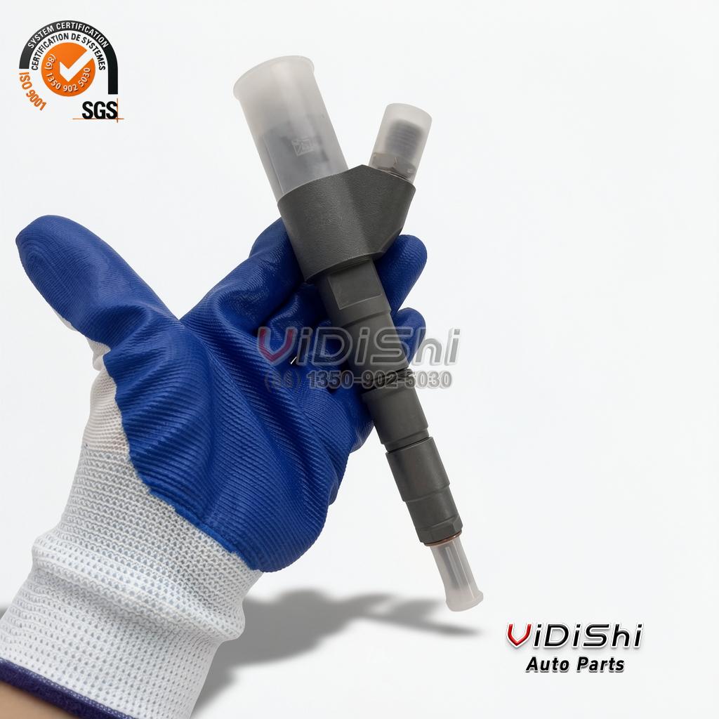 A 0445120067 injector held upright in a gloved hand, showing the whole assembly beside the hand for scale