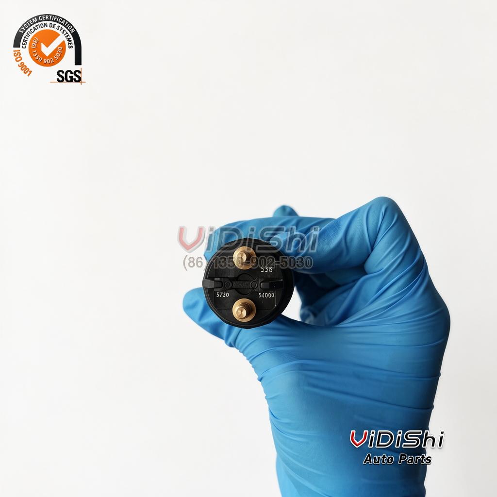 All Products 14 0445120538 injector valve cap with its printed code block, held in a gloved hand