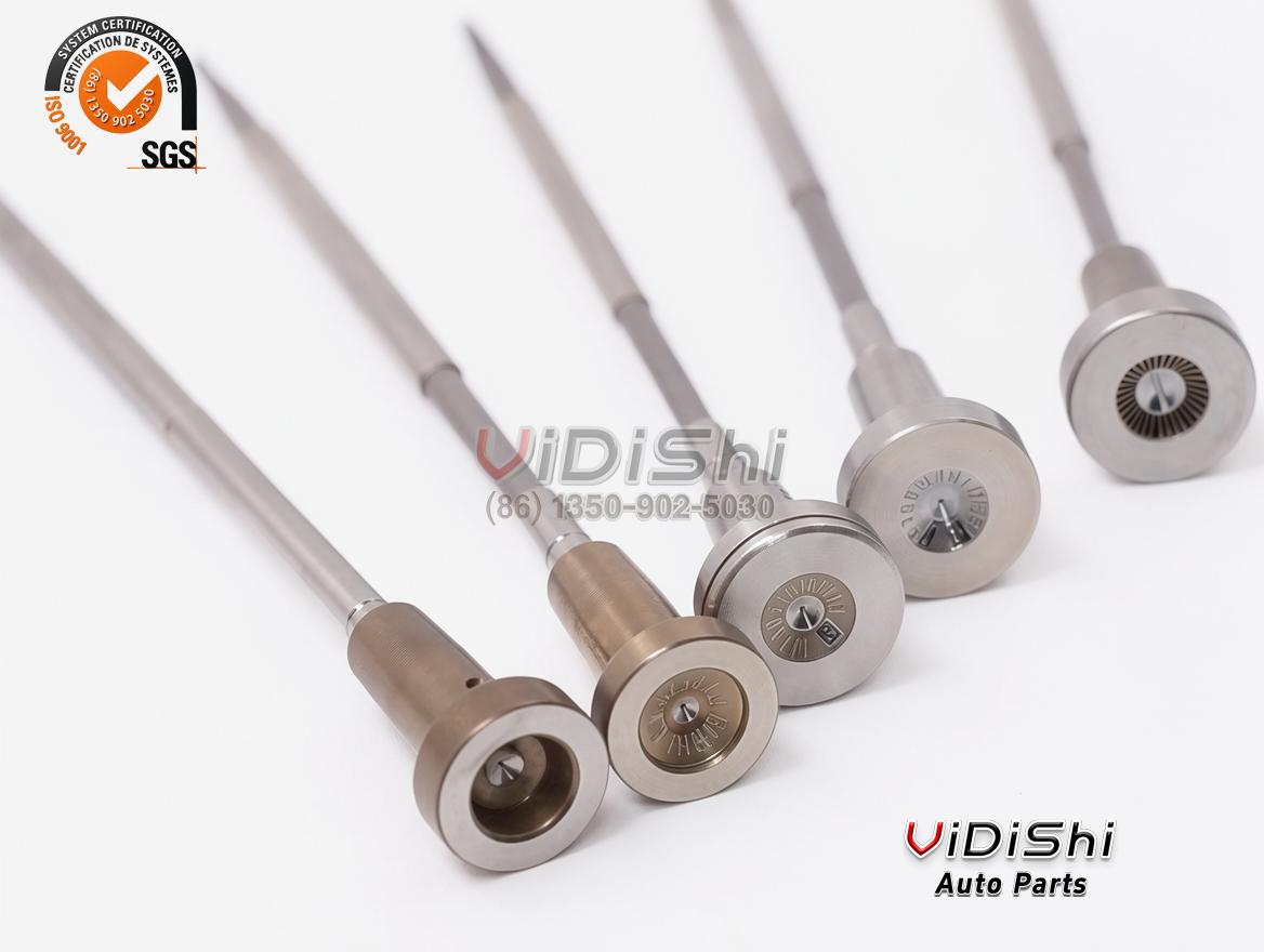 Close-up of F00ZC01305 valve cap faces and stems showing engraved calibration marks