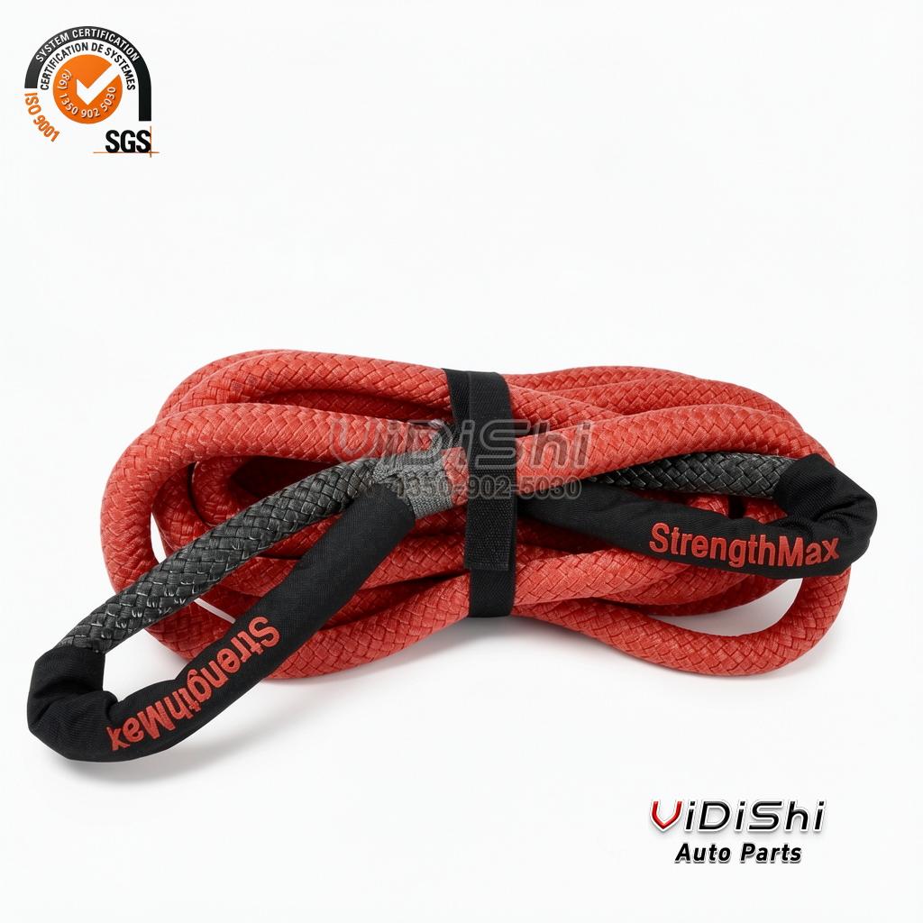 Red synthetic recovery rope coiled with a black protective sleeve